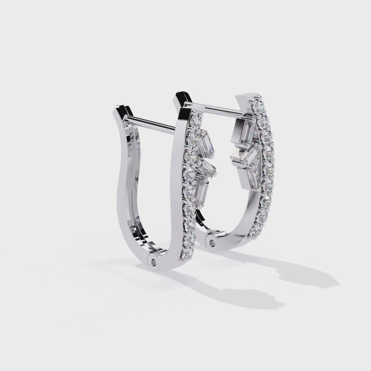 Silver hoop earrings with diamonds on a white background