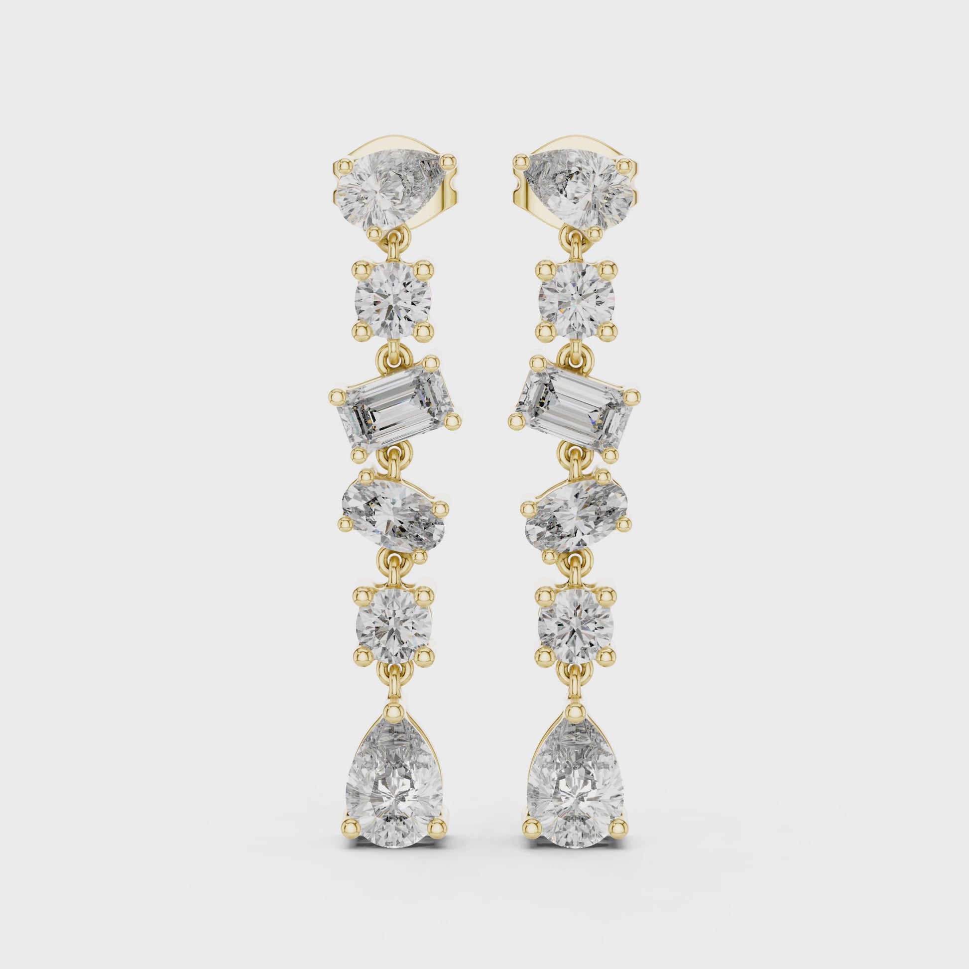 Gold and diamond earrings on a white background