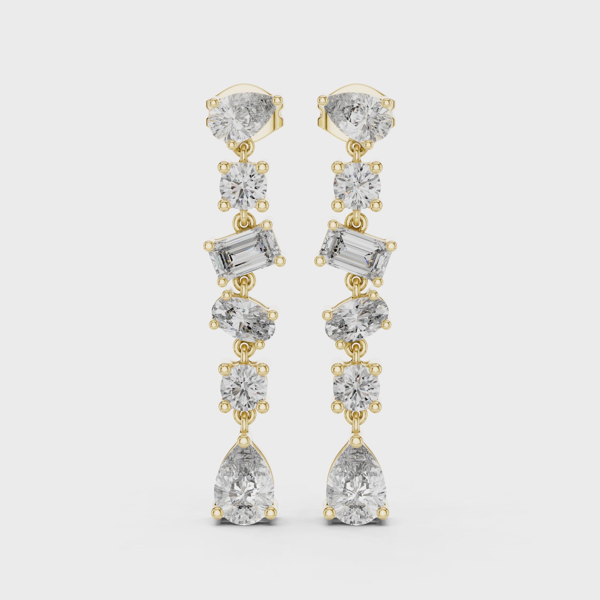 Gold and diamond earrings on a white background