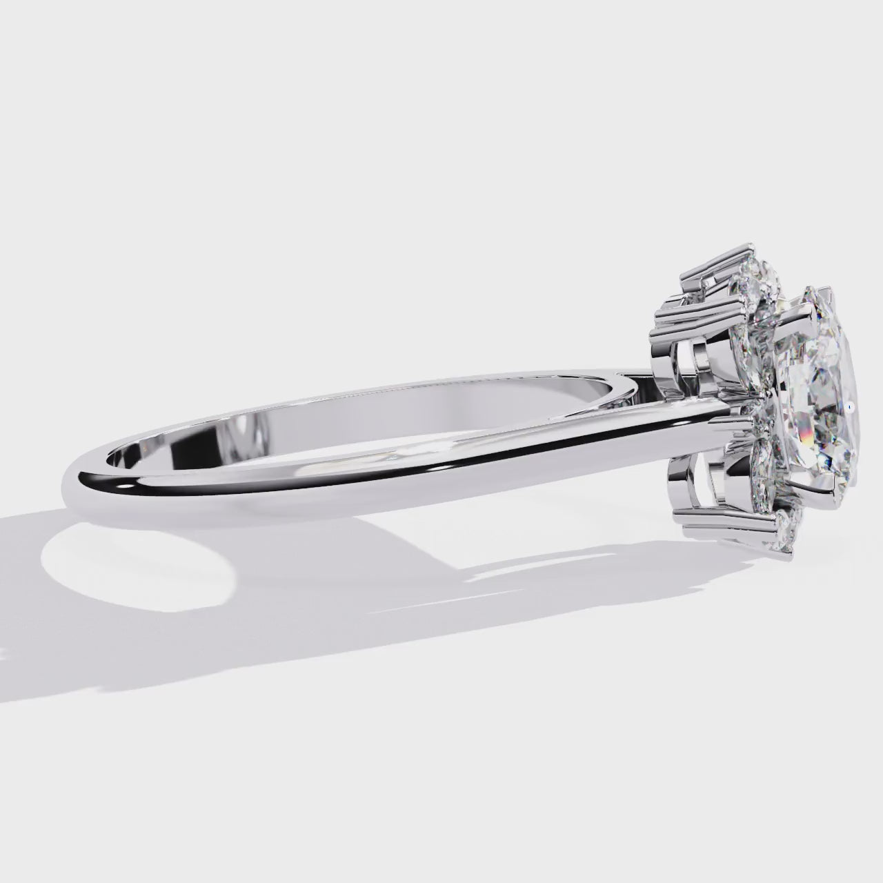 ring features a brilliant Oval centre framed by a unique mosaic halo of alternating Round and Marquise diamonds