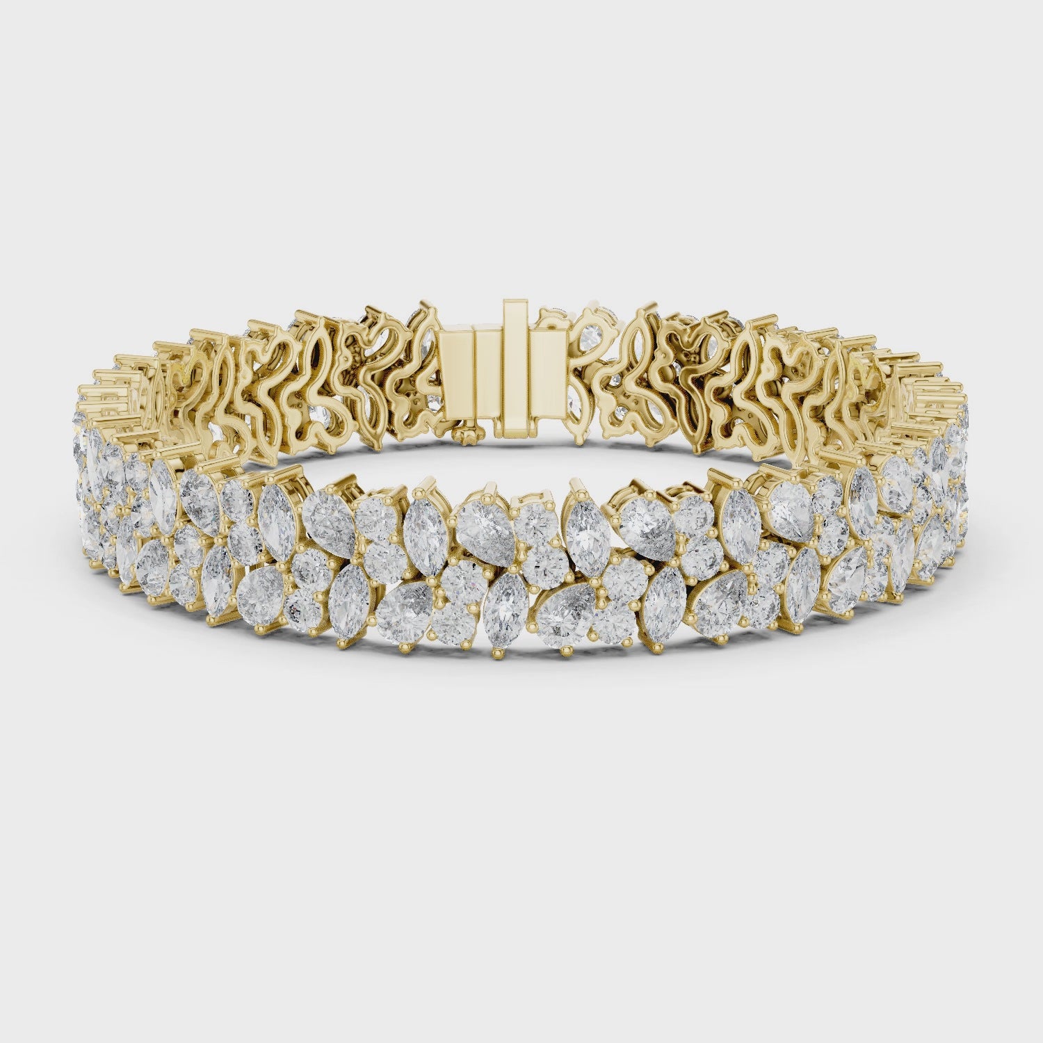 Gold bracelet with pear and marquise diamonds on a white background