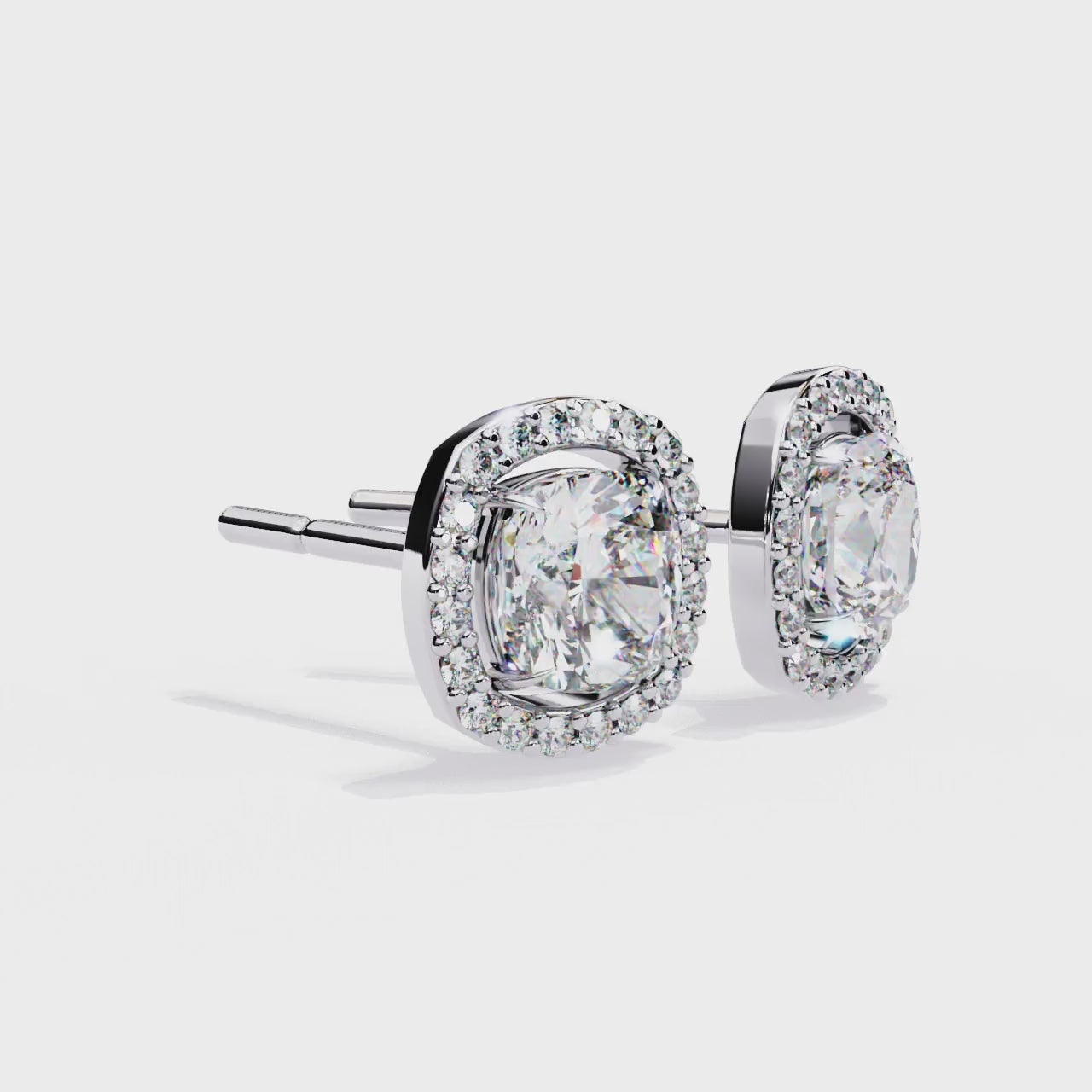 Pair of white gold and diamond earrings on a white background