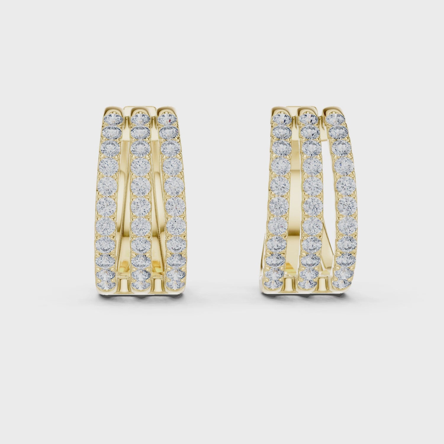 Gold hoop earrings with diamond accents on a white background