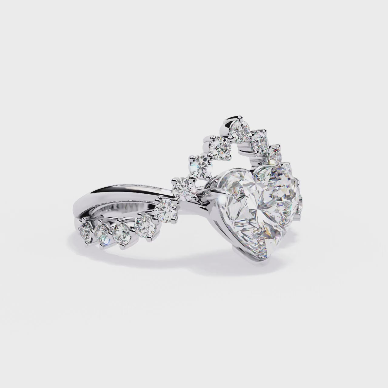 ring features a magnificent Heart-shaped diamond set atop a sophisticated dual-band V-shape architecture