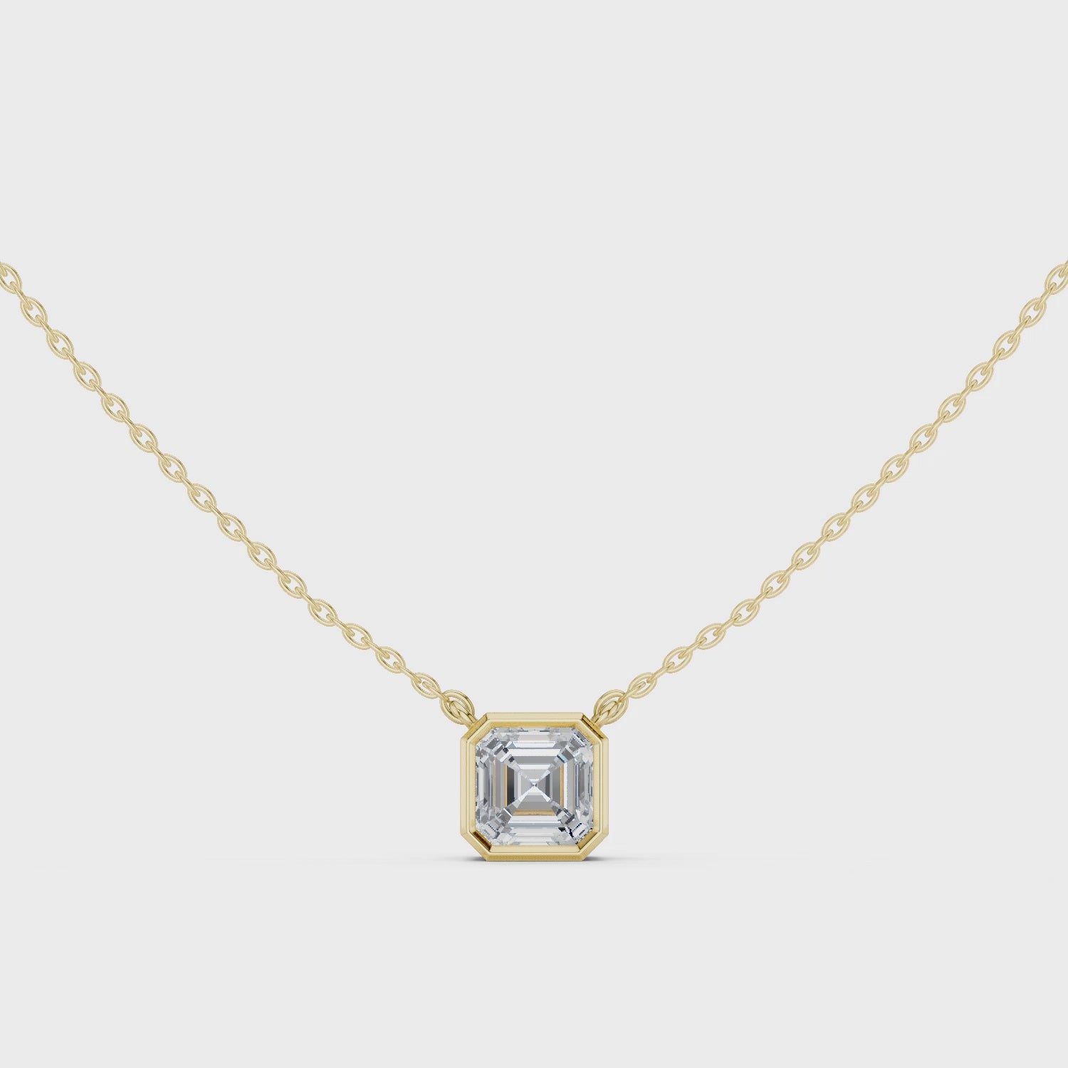 Gold necklace with a diamond pendant on a white background