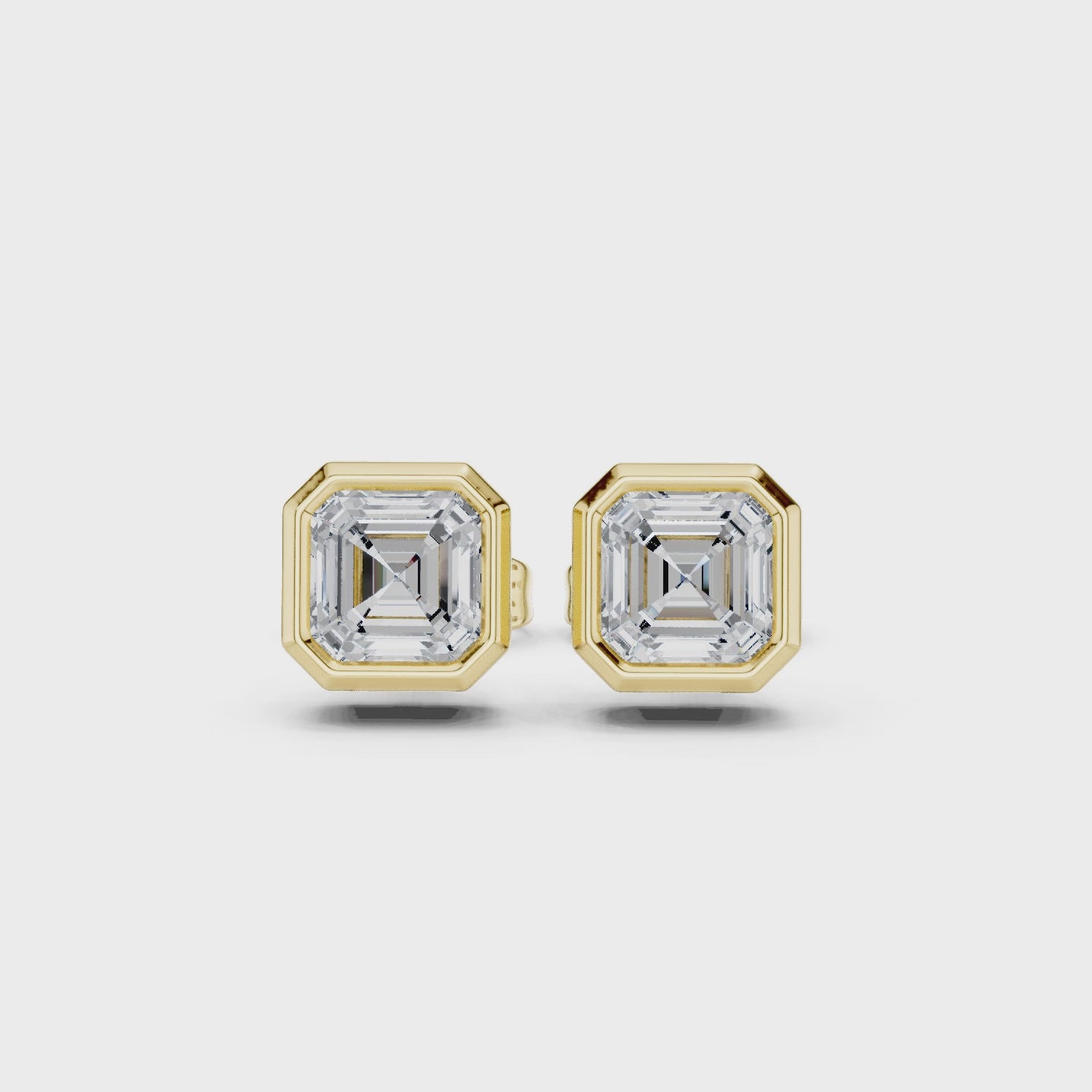 Gold square stud earrings on a white background