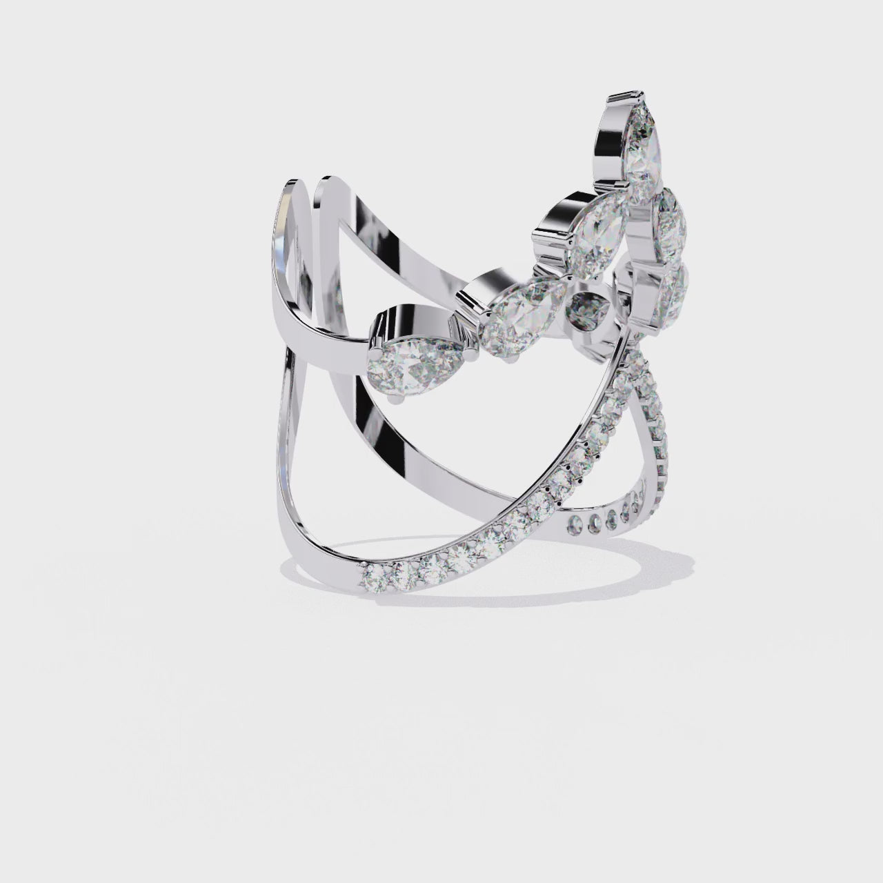 ring features a sophisticated dual-band V-shape architecture encrusted with shimmering Pear and Round diamonds