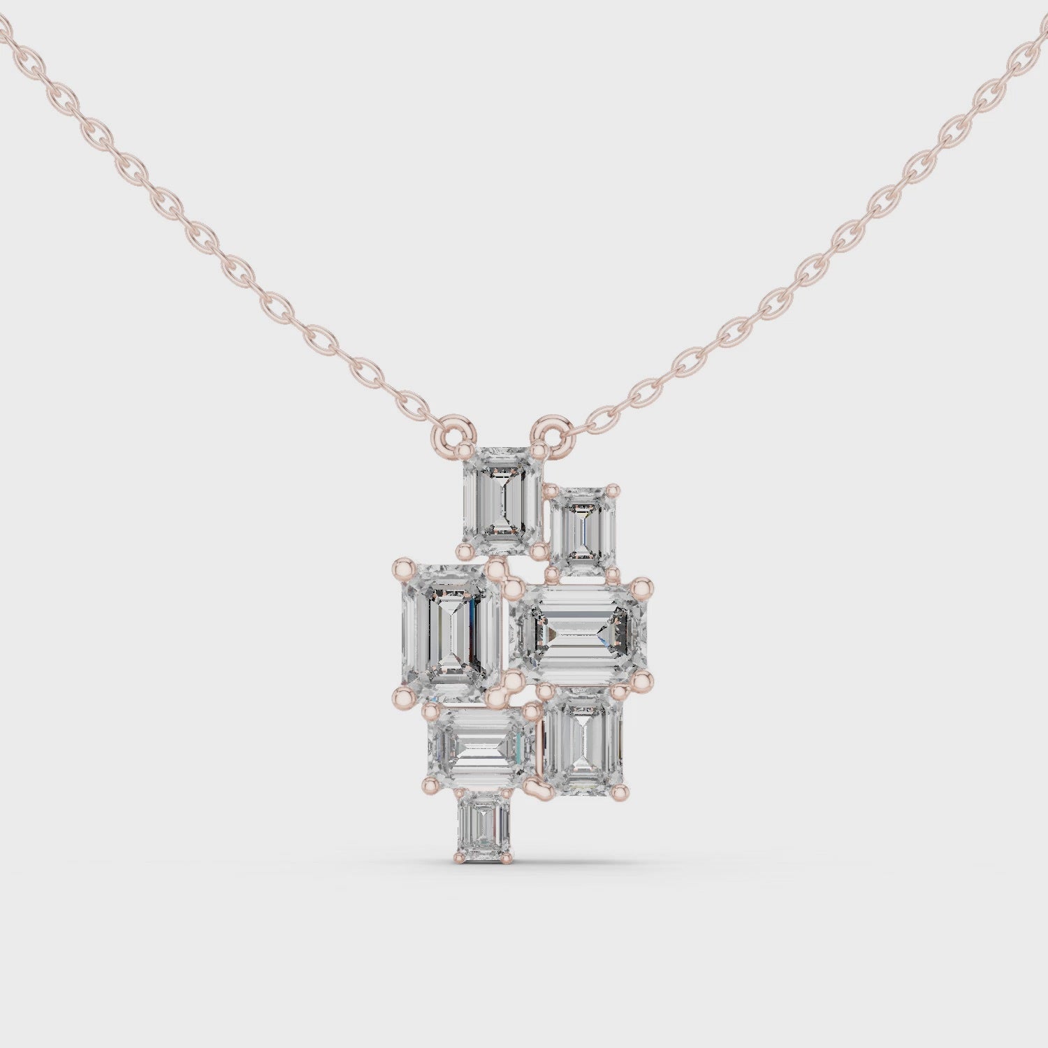 Gold necklace with a geometric pendant on a white background