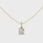 Cushion-cut diamond suspended from an elongated bail encrusted with hand-set pavé diamonds