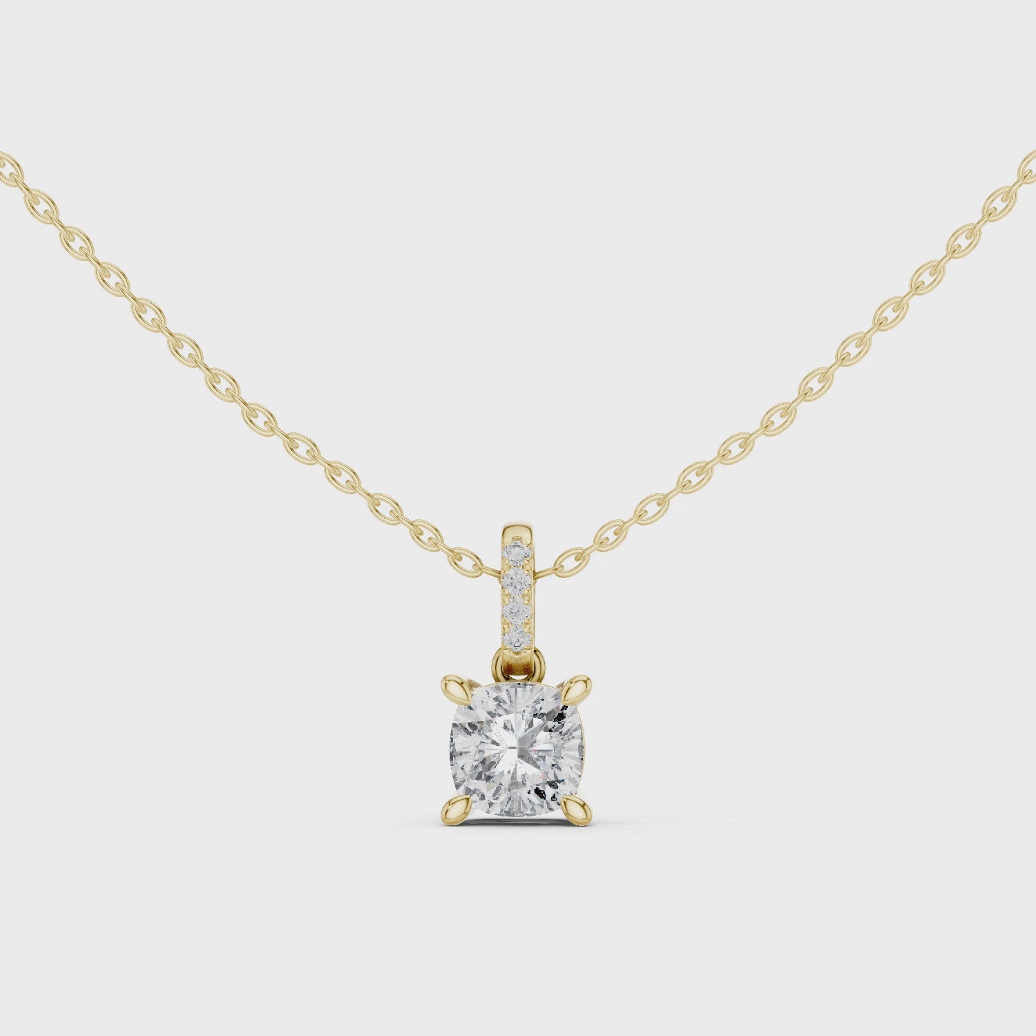 Cushion-cut diamond suspended from an elongated bail encrusted with hand-set pavé diamonds
