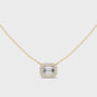 Gold necklace with a emerald diamond pendant on a white background