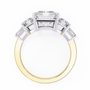 ring features a substantial Radiant-cut solitaire flanked by matching Radiant and Baguette-cut side stones
