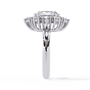 ring showcases a brilliant Radiant-cut diamond framed by an exquisite floral-inspired cluster halo