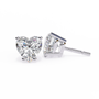 Heart-shaped and rectangular diamond stud earrings on a white background