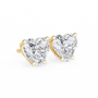 Heart-shaped diamond earrings with gold settings on a white background