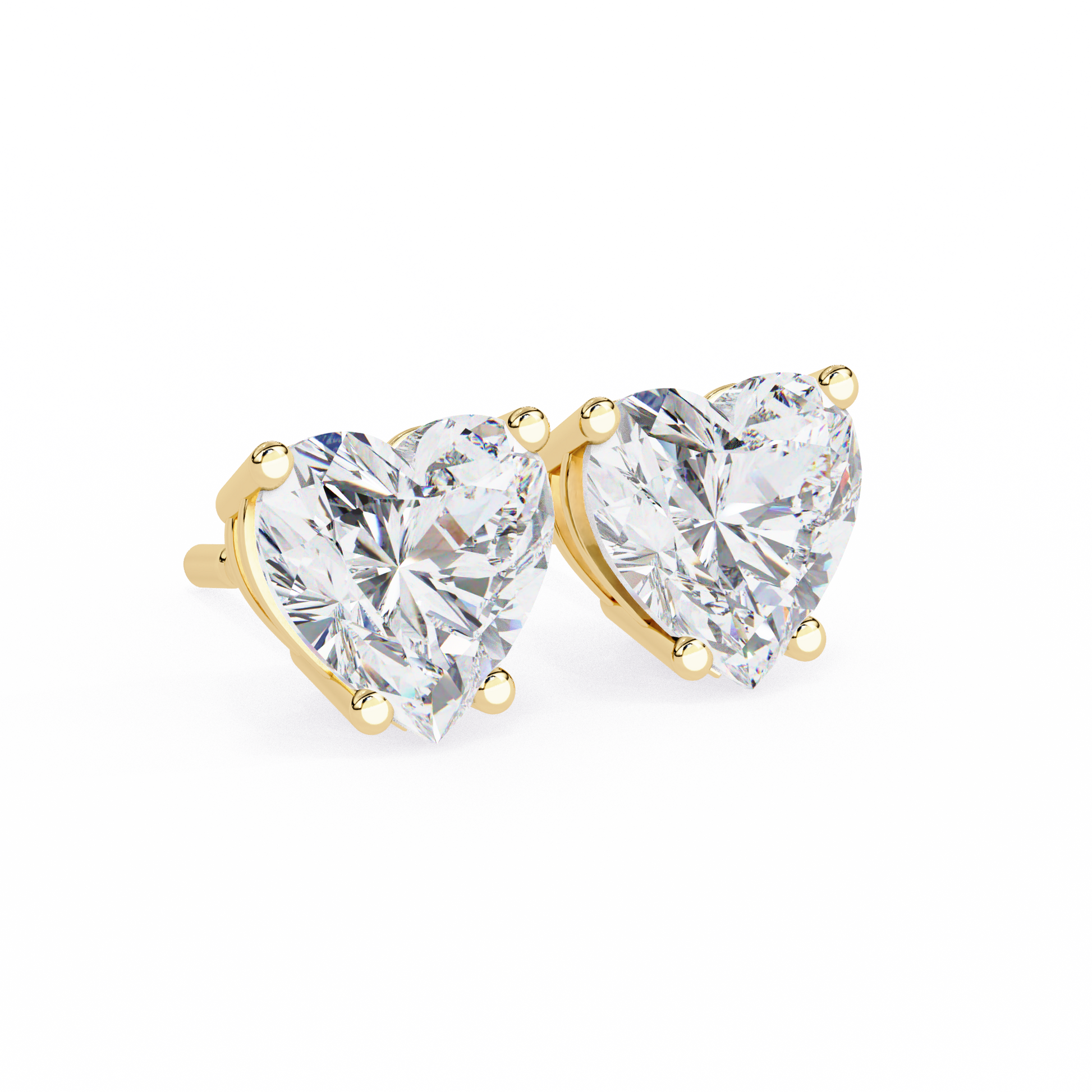 Heart-shaped diamond earrings with gold settings on a white background