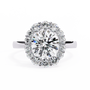 Features a brilliant Round Diamond centre framed by an oversized halo of shimmering accent diamonds