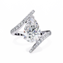 ring features a magnificent Pear diamond held within a sophisticated spiral-esque bypass band