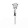 Cushion-cut solitaire flanked by two perfectly matched cushion-cut side stones