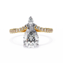 features a Pear-shaped diamond centre set atop a modern V-contoured band, which terminates in a delicate accent pear diamond tail
